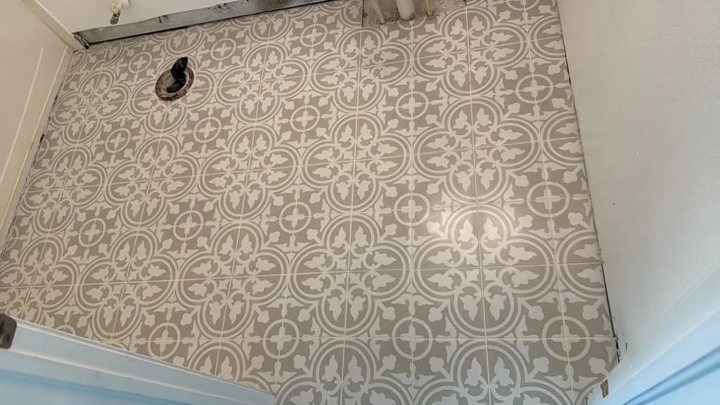 Installer setting large-format tile on a leveled subfloor in a Tampa Bay home